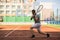 Young man practice on tennis court in university campus