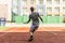 Young man practice on tennis court in university campus