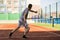 Young man practice on tennis court in university campus