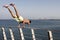 Young man practicing calisthenics at a pier in Puerto Vallarta