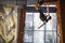 Young man practicing rock-climbing in climbing gym