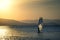 Young man practicing surf in Trabucador Beach, Tarragona. Spanish beach and tourism with empty copy space