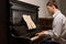 Young man practising at a piano