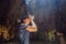 Young man praying in a Buddhist temple holding incense Huyen Khong Cave with shrines, Marble mountains, Vietnam