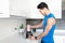 Young Man Preparing Healthy Drink In Kitchen