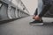 Young man preparing to run in the city, tying jogging shoes