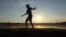 Young man presents a ballroom dance on a lake bank