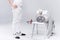 Young man professional fencer standing near chair with fencing equipment