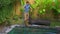 Young man professional swimming pool cleaner does pool cleaning service