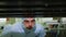 Young man in protective suit checks solar panels in workshop