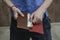 A young man pulls out $ 5 from a leather wallet