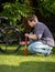 Young man pumping bicycle wheel with air pump