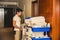 Young man pushing a housekeeping cart in a hotel