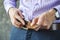 Young Man Puts on a Belt in Trousers Close Up