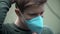 Young man puts medical mask outside; protection against coronavirus COVID-19