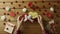 Young man puts valentine heart onto the gift box, top view