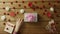 Young man puts valentine onto present box, top view