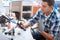 Young man putting together drone propeller and other details