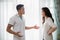 Young man quarreling with his wife at home while screaming and s