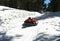 A Young Man Races Down a Snowy Hill in Winter