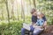 Young man reading bible to child