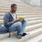 Young man reading book in campus copy space