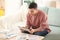 Young man reading news on tablet screen indoors