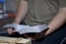 A young man reads the Bible, laying it on a wooden plank of boards.