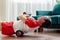 A young man in red shorts is doing exercises on a foam roller, works out of the muscles with a massage roller. Athletic