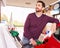 Young man refuelling a car at a petrol station