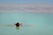 The young man relaxes and swims in the water of the Dead Sea in Israel. tourism, health improvement, recreation, healthy lifestyle