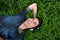 Young man relaxing with headphones outdoors - from above