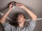 Young man repairing cable wiring and installs or replaces the halogen lamp on the ceiling