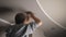 A young man is repairing a ceiling soffit. Replacing the LED lamp at the downlight