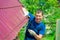 A young man repairs the roof of the house in overalls