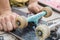 Young man repairs a skateboard and changes wheel sets