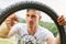 Young man repairs tire hoop