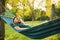 Young man resting in comfortable hammock