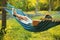 Young man resting in comfortable hammock at garden