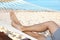 Young man resting in hammock at seaside