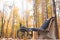 Young man resting sitting on a bench with his legs on his wheelchair.