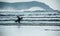 Young man returns ashore after good days surfing, Fistral beach, Newquay, Cornwall