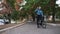 young man rides a bicycle, stops and drinks water from a bottle