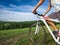 Young man riding on a bicycle on green meadow