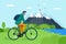 Young man riding bicycle in mountains. Boy bicyclist tourist with backpack on bike travel in nature. Male cyclist active