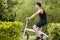 Young man riding on the bicycle on the pathway.