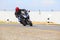 Young man riding big bike motorcycle on sharp curve asphalt road