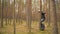 Young man riding on ecological electric transport. Adult driving unicycle, balancing electric wheel through the forest