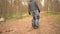 Young man riding on ecological electric transport. Adult driving unicycle, balancing electric wheel through the forest