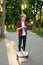 Young man riding on mini gyro board with laptop